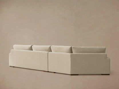 Beige Norwalk Two-Piece Cuddle Chaise Sectional with plush seat and back cushions, featuring a modern, clean-lined design.