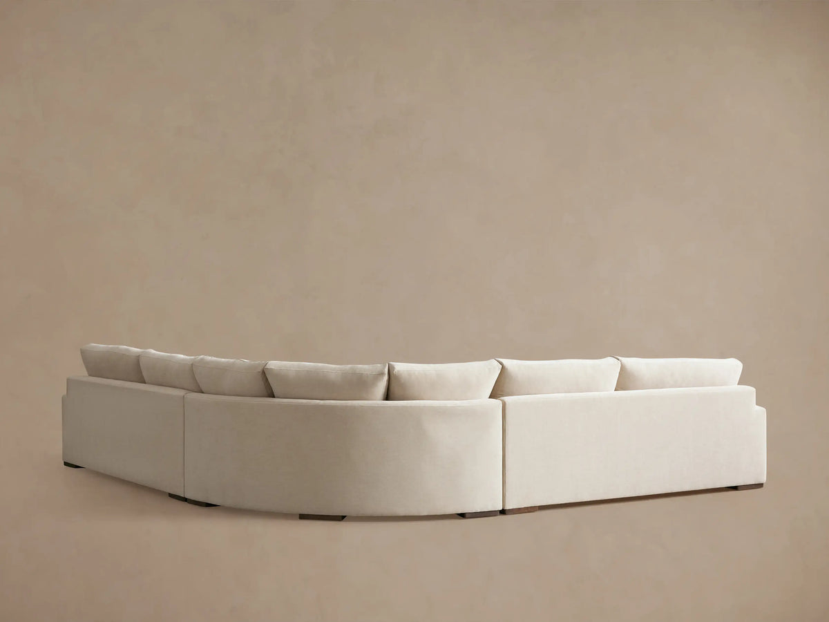 Norwalk Three-Piece Corner Wedge Sectional in beige fabric, showcasing plush cushions and wide armrest on a beige background.
