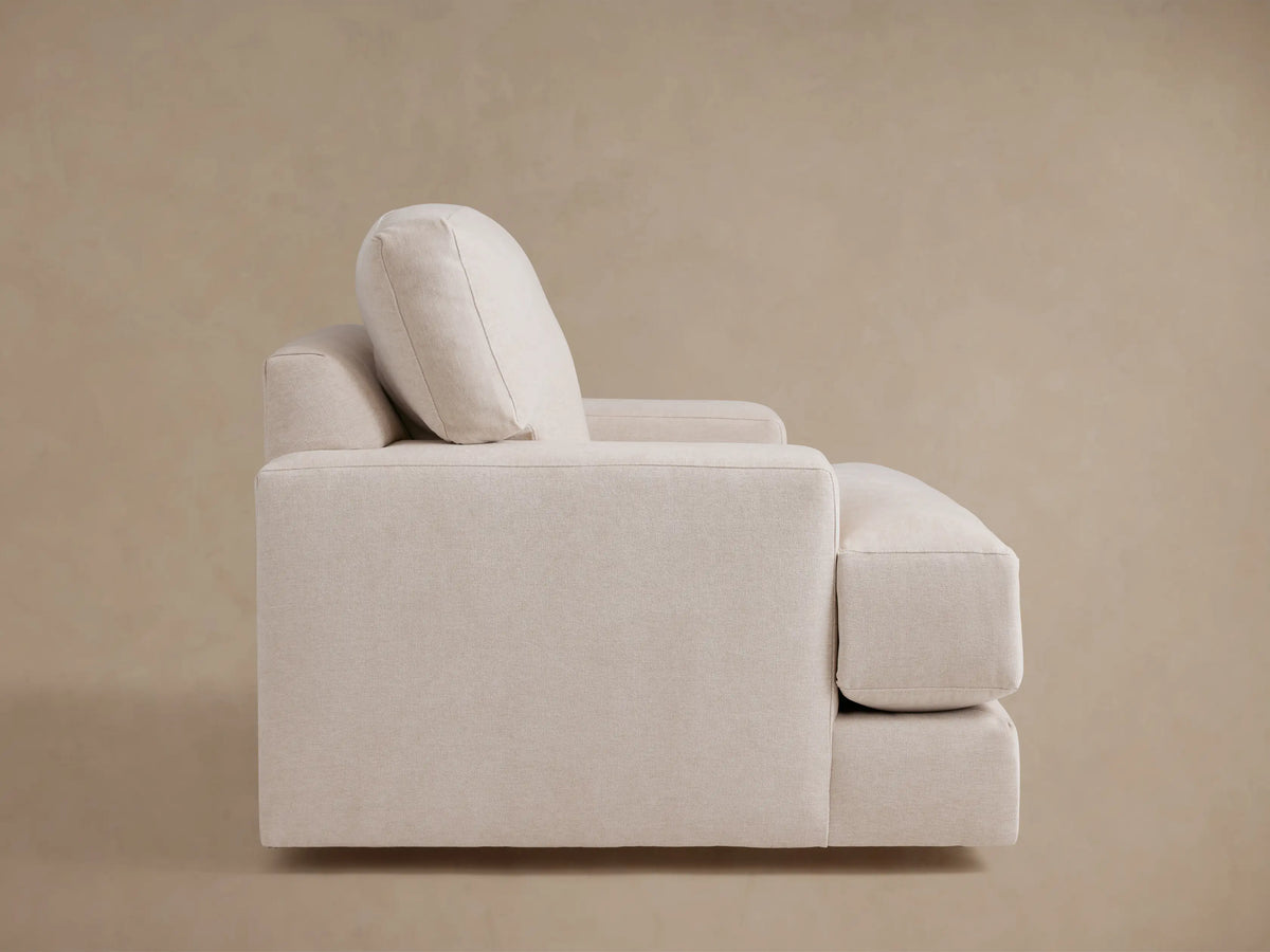 Norwalk Swivel Chair in neutral fabric, showcasing plush seat and back cushions, with visible armrests and beige upholstery.