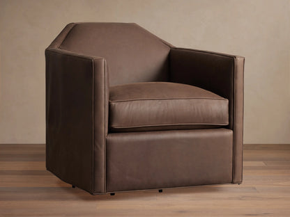 Marina Leather Swivel Chair. Brown leather armchair with an angular design, plush cushion, and integrated swivel base on wood floor.