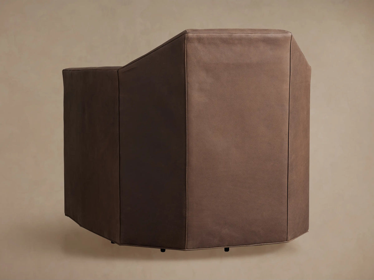 Close-up of a Marina Leather Swivel Chair, highlighting its rich brown leather upholstery, detailed stitching on the armrest and seat.