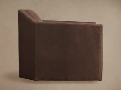 Angled rear view of the Marina Leather Swivel Chair, showcasing its geometric design in rich, variegated brown leather upholstery.