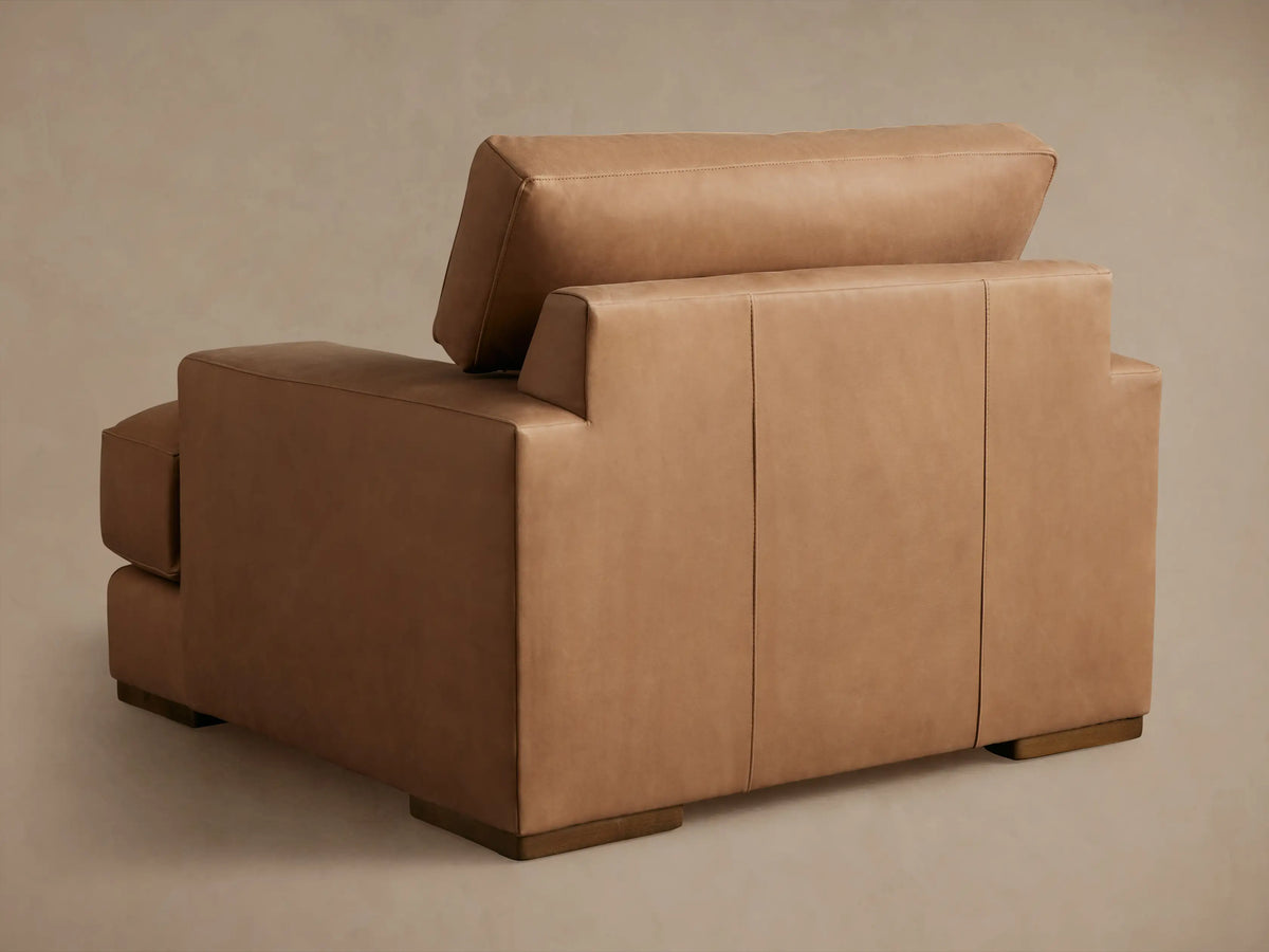 Brown Norwalk Leather Chair with close-up of armrest and seat. Smooth, richly colored leather with fine stitching detail.