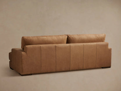 Norwalk Leather Sofa in light brown leather, showcasing a deep seat cushion, padded armrest, and plush backrest with visible seams.