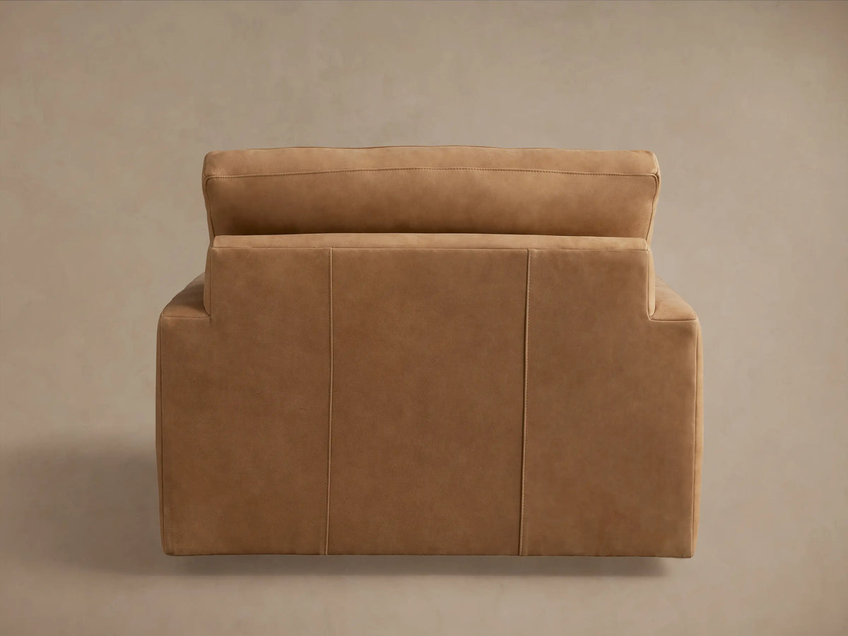 Norwalk Leather Swivel Chair in tan leather, featuring a plush backrest and seat cushions, with a boxy, modern design.