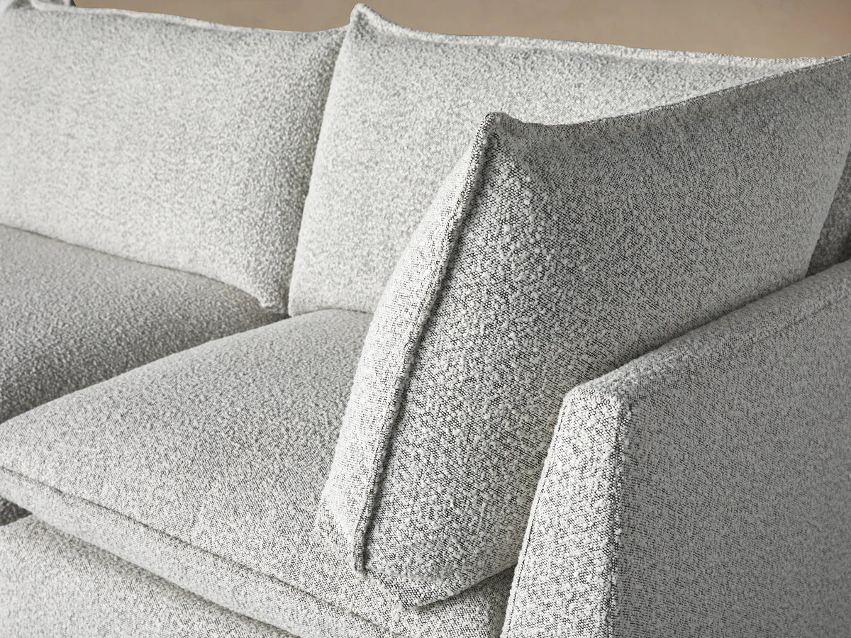 Owen Three-Piece Modular Sofa, light grey textured fabric. Three modular sections, soft cushions, two throw pillows with dark piping.