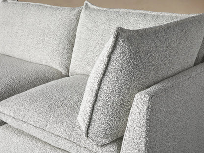Owen Three-Piece Modular Sofa, light grey textured fabric. Three modular sections, soft cushions, two throw pillows with dark piping.