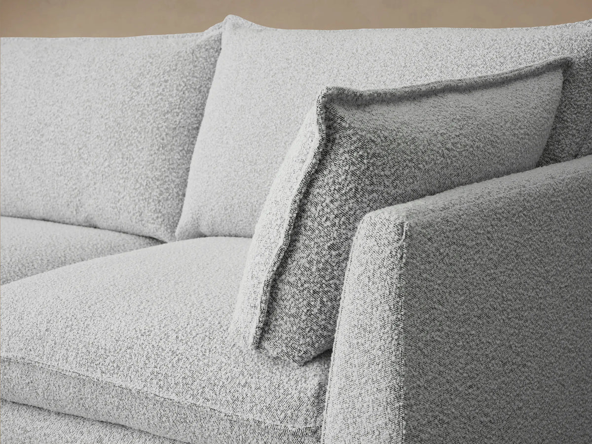 Owen Four-Piece Sectional in light grey textured Burbank Pepper fabric, with left chaise, 2 seats, and right arm, on wood floor.