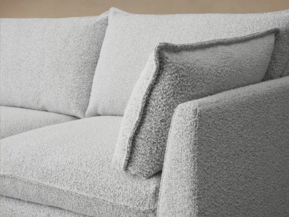 Owen Four-Piece Sectional in light grey textured Burbank Pepper fabric, with left chaise, 2 seats, and right arm, on wood floor.