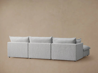 Close-up of Owen Four-Piece Sectional in Burbank Pepper, showing textured gray fabric on cushions, armrest, and throw pillow.
