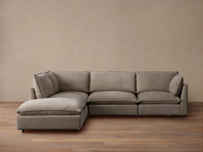 Owen Nubuck Leather Five-Piece Sectional, L-shaped, soft taupe, plush cushions, on a wood floor, tan wall background.