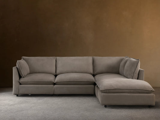 Owen Nubuck Leather Five-Piece Sectional, L-shaped, soft taupe, plush cushions, on a wood floor, tan wall background.