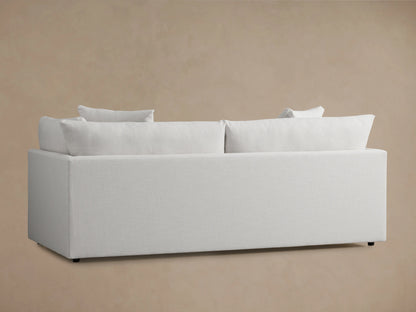 Pavo Sofa in Barbados Cream, back view. Features plush, full-length back cushions, and a minimalist rectangular frame against a neutral background.