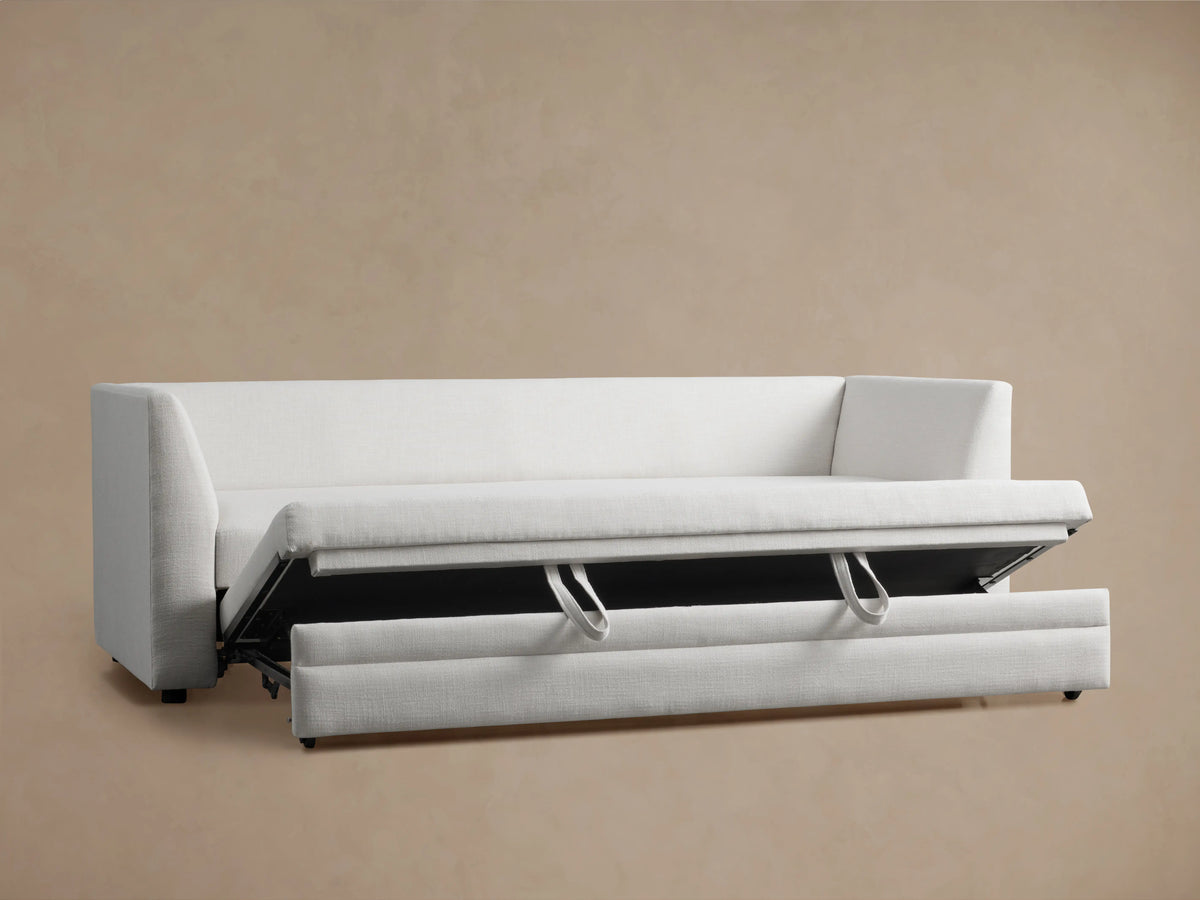 Pavo Trundle Sleeper Sofa in Barbados Cream fabric, shown from the back with two cushioned backrests against a beige background.