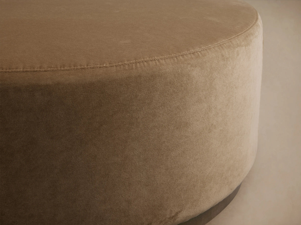 Ryles Plinth Ottoman in beige fabric, close-up of round edge and smooth texture on a subtle background.