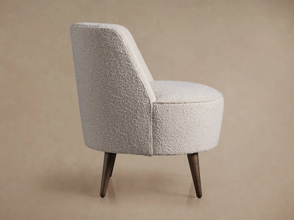 Rear view Ryles Chair. Cream boucle fabric, rounded back, dark brown flared wooden legs on neutral background.