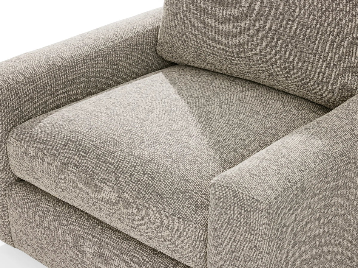 Back view of the Remington Outdoor Swivel Chair in beige fabric, showcasing a rectangular shape with cushion detailing.
