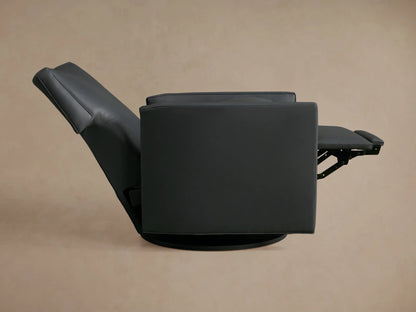 Close-up, angled view of a dark grey leather Rudy Swivel Recliner, showing the seat, back cushions, and padded armrest.