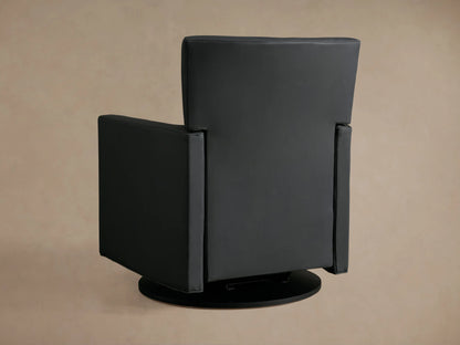 Black leather Rudy Swivel Recliner, partially reclined with footrest extended, on a round black base, against a neutral wall.
