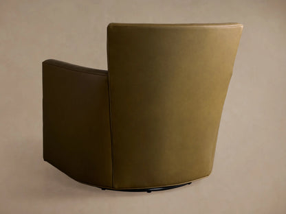 Detail shot of the Rudy Leather Swivel Chair, featuring an olive-green leather arm and seat cushion with elegant piping.