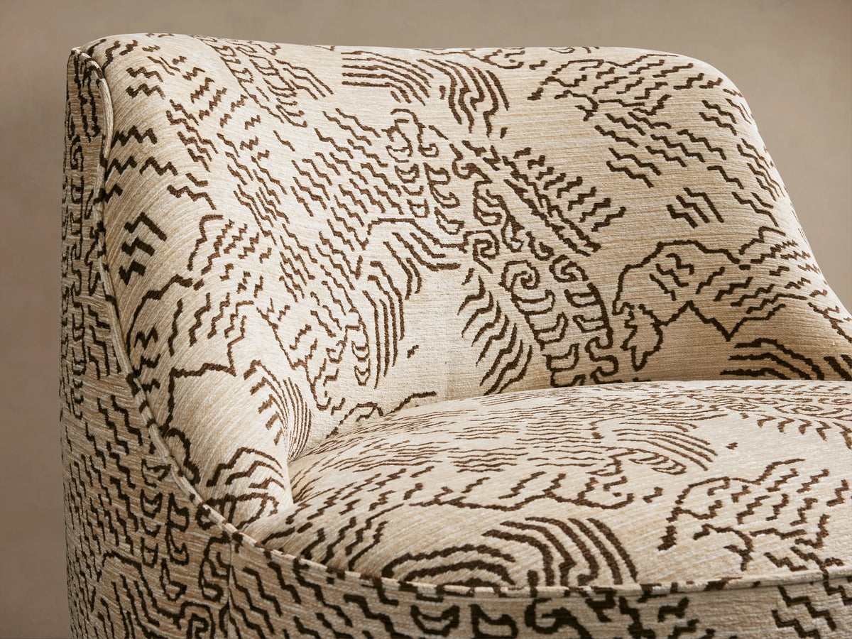Sonny Swivel Chair, upholstered in beige fabric with dark brown abstract wavy lines, front-angled view on wood floor.