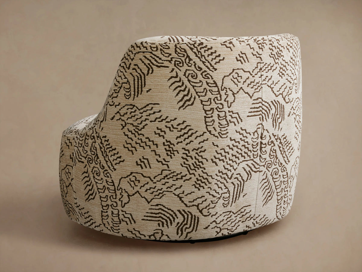 Close-up of a Sonny Swivel Chair upholstered in a beige fabric with intricate dark brown abstract wavy patterns, angled view.