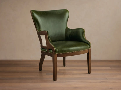 Front view of the green leather Tilly Leather Chair with a dark wooden frame and brass nailhead detailing.