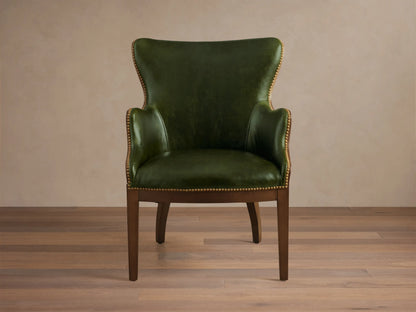 Front view of the green leather Tilly Leather Chair with a dark wooden frame and brass nailhead detailing.