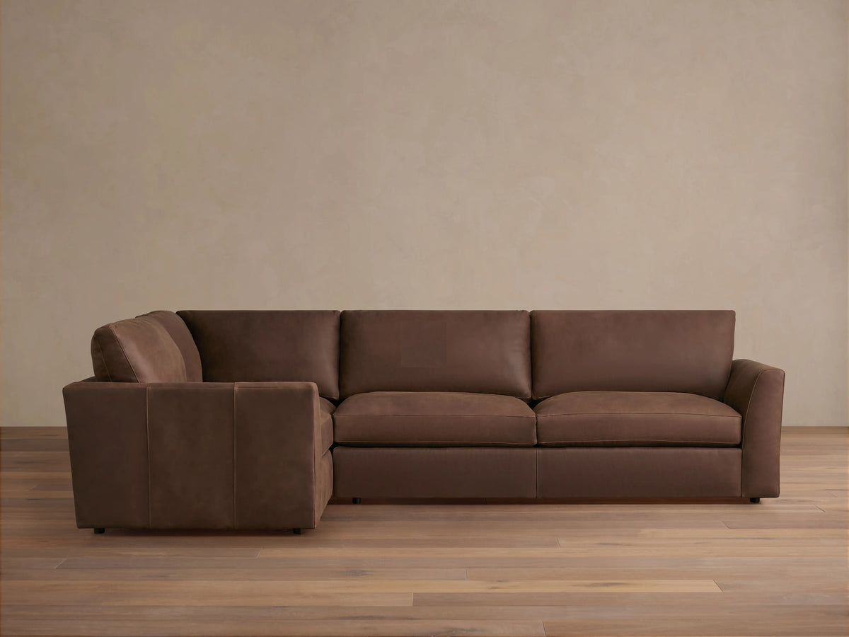 Brown Vernon Leather Two-Piece Sectional, L-shaped, on light wood floor, features plush cushions and a smooth finish.