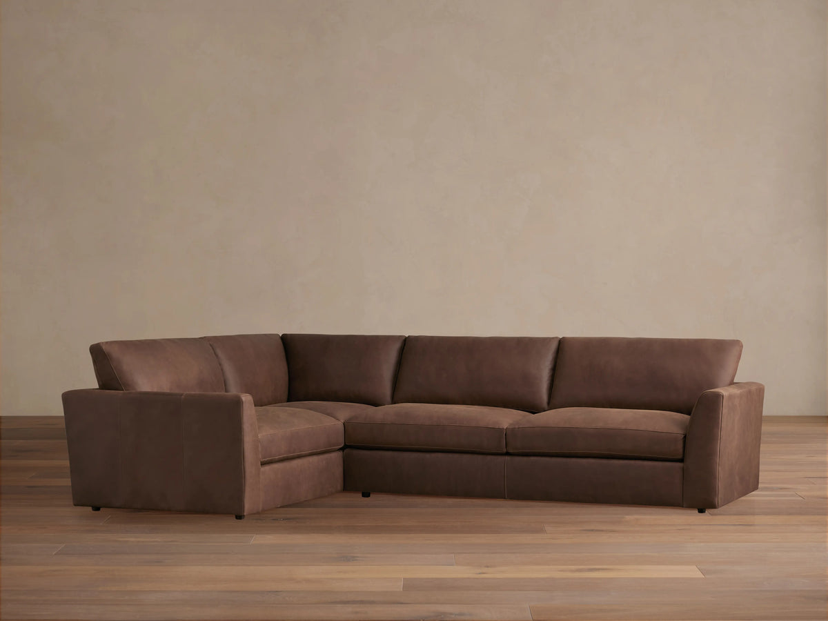 Brown Vernon Leather Two-Piece Sectional, L-shaped, on light wood floor, features plush cushions and a smooth finish.