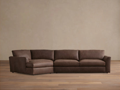 Vernon Leather Two-Piece Cuddle Chaise Sectional in rich brown leather. Left-side chaise, right armrest, plush cushions on hardwood floor.