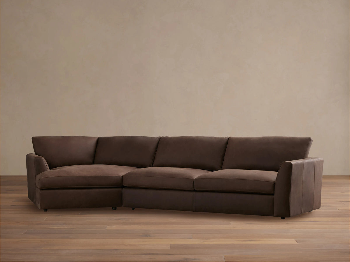 Vernon Leather Two-Piece Cuddle Chaise Sectional in rich brown leather. Left-side chaise, right armrest, plush cushions on hardwood floor.