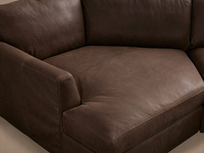 Vernon Leather Two-Piece Cuddle Chaise Sectional in rich brown leather, featuring plush cushions and a sleek design, set in a minimalistic room.