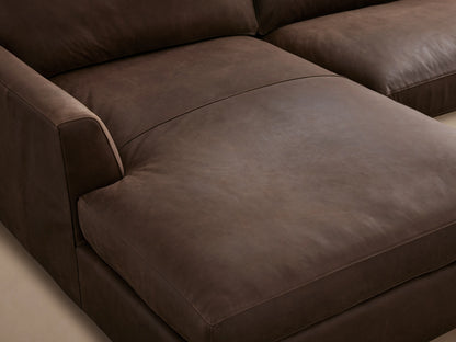 Brown Vernon Leather Two-Piece Chaise Sectional on wooden floor, featuring L-shaped design, cushioned seats, and sleek armrests.