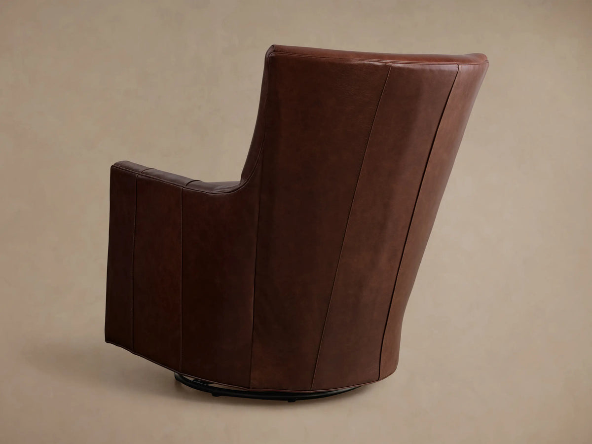 Front view of a brown Walton Leather Swivel Glider, with a cushioned seat and back, resting on a black circular swivel base.