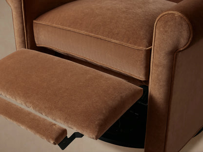 Rudy Rolled Arm Swivel Recliner in cognac velvet, featuring rolled arms, cushioned seat, and black swivel base on wooden floor.