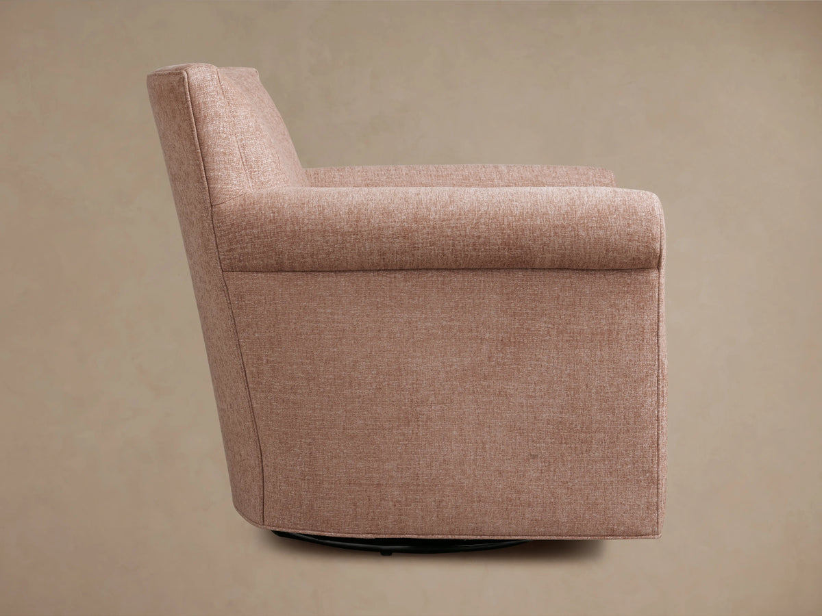 Rolled arm of the Rudy Swivel Chair in cognac velvet. Close-up showing soft texture and detailed stitching.