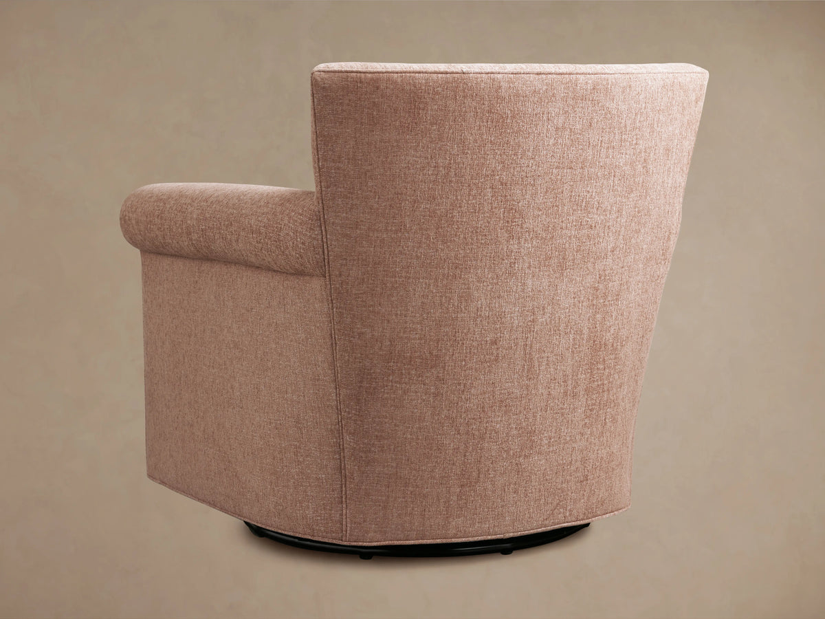 Rudy Rolled Arm Swivel Chair in side view, showing a plush, fabric-covered design with rolled arms and a swivel base in a warm, neutral color.