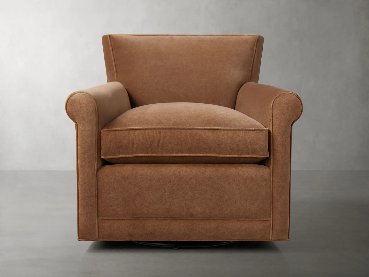 Rudy Rolled Arm Swivel Chair in Banks Cognac, featuring rolled arms, plush seat cushion, and 360-degree swivel on a neutral background.