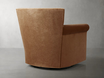 Rudy Rolled Arm Swivel Chair in Banks Cognac fabric, featuring plush seat and backrest, rolled arms, and a swivel base on a gray floor.