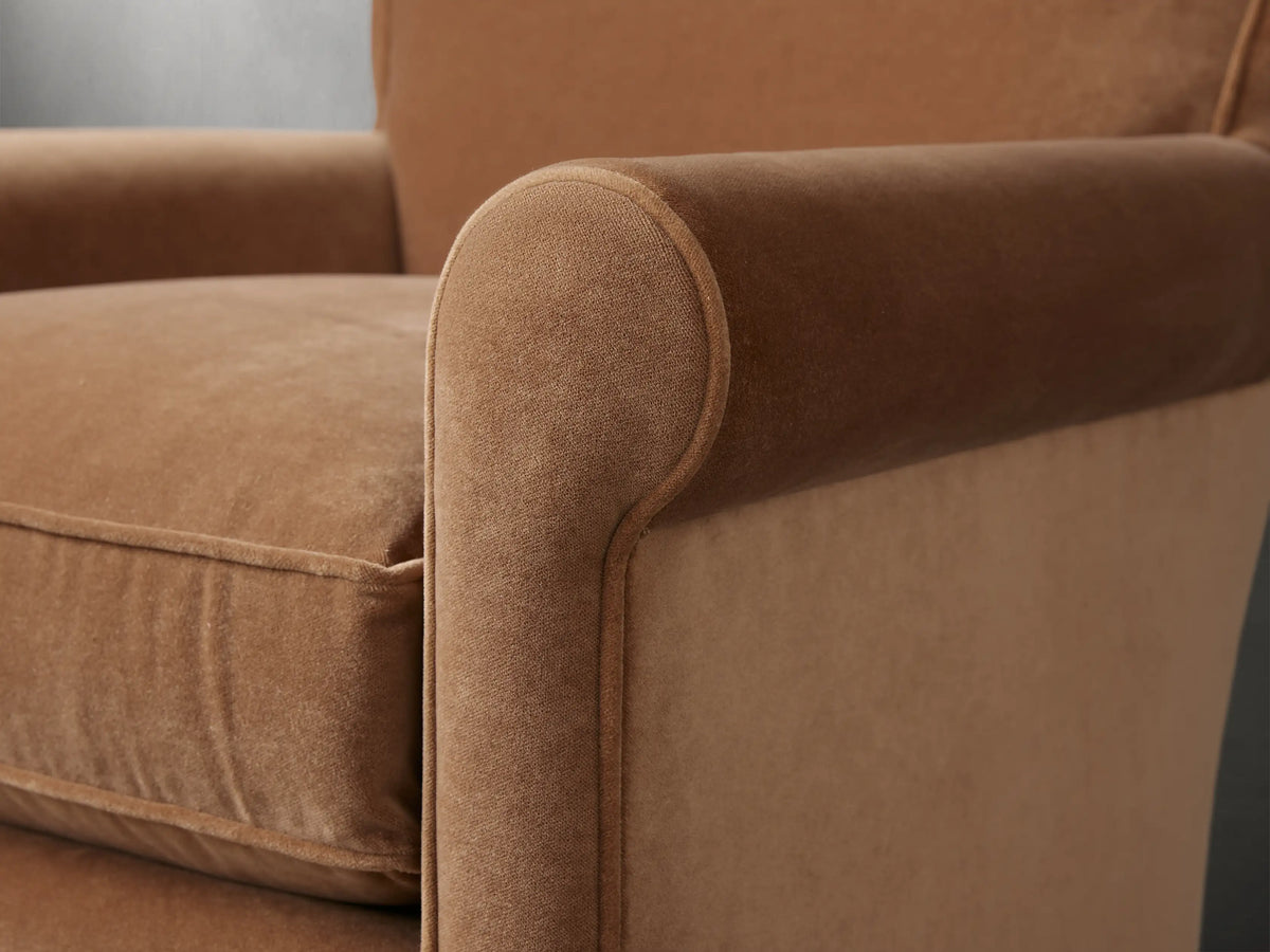 Rudy Rolled Arm Swivel Chair in Banks Cognac, back view, showing rich brown velvet upholstery, cylindrical shape, black swivel base.