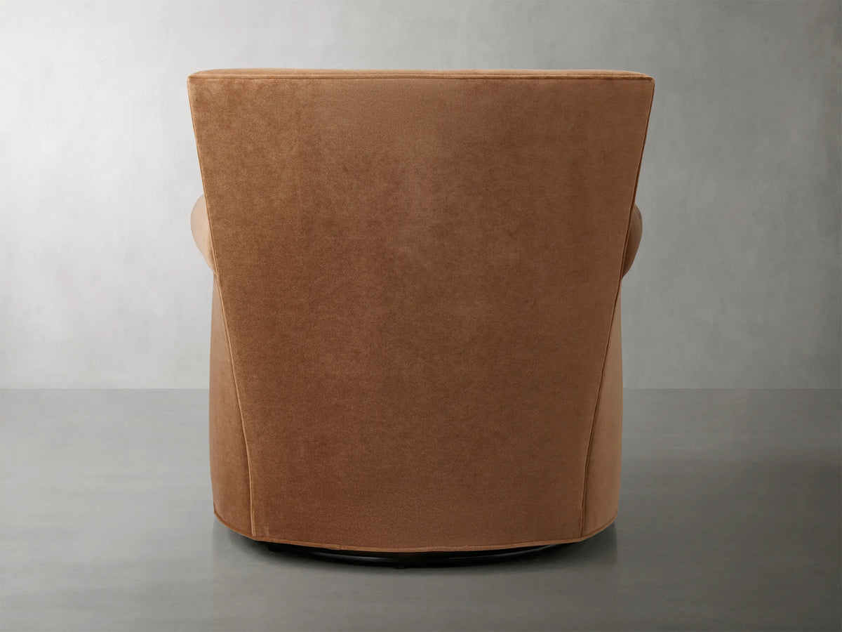 Rolled arm of Rudy Swivel Chair in Banks Cognac velvet, showcasing smooth texture and rich brown color.