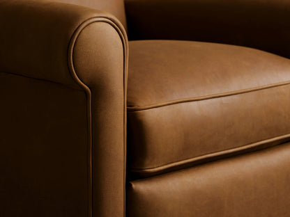 Brown leather Rudy Swivel Recliner detail showing rolled arm and angled seat cushion in close-up view.
