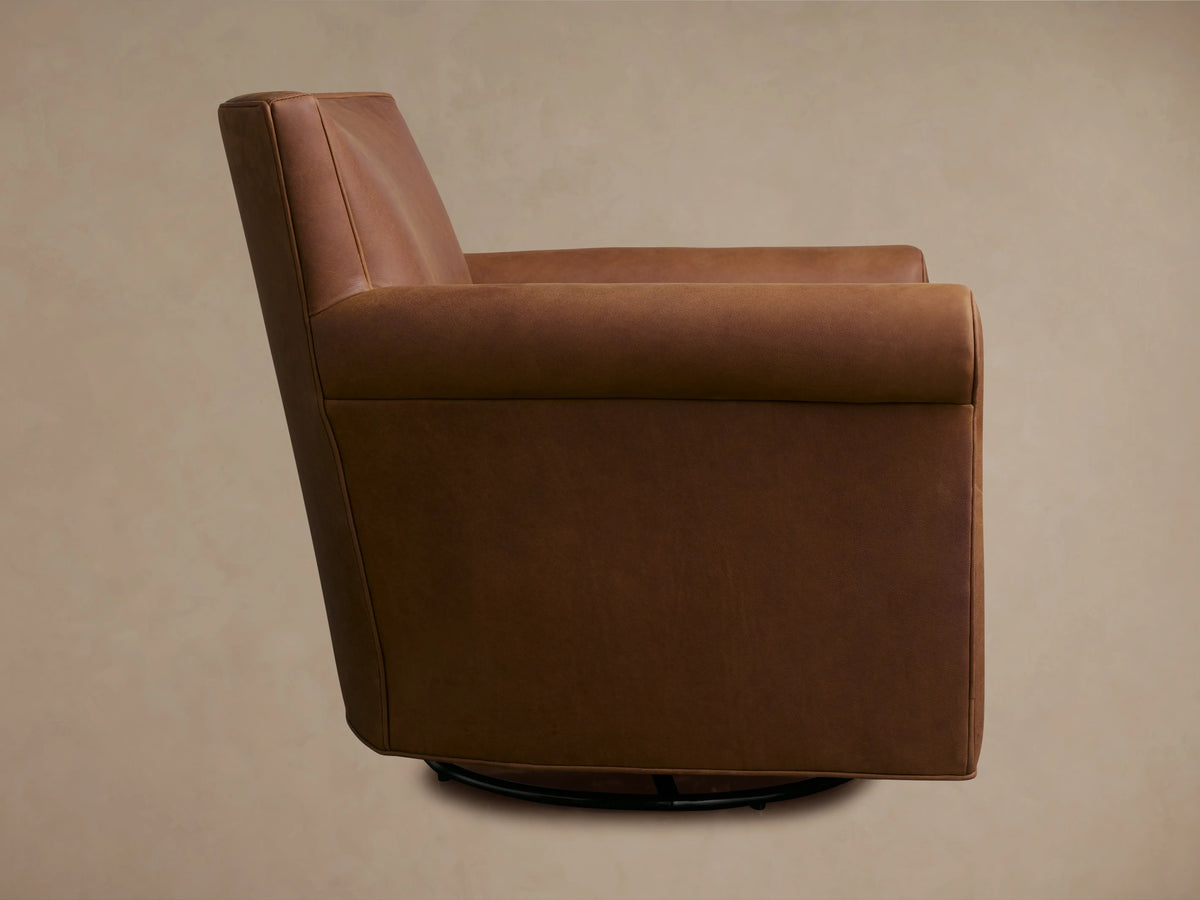 Rudy Leather Rolled Arm Swivel Chair in rich brown leather, featuring rolled arms and plush cushions with visible stitching.