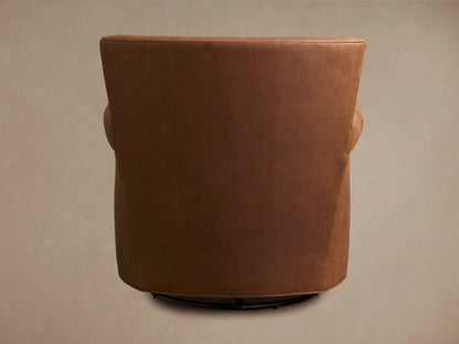 Rudy Leather Rolled Arm Swivel Chair in brown leather shown from a side angle. Features rolled arm, smooth finish, and visible swivel base.