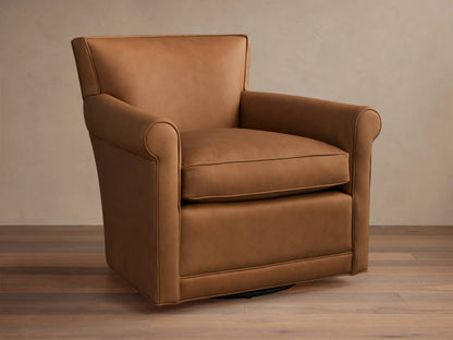 Warm tan leather Rudy Rolled Arm Swivel Chair, featuring rolled arms, a plump seat cushion, and a discreet black swivel base.