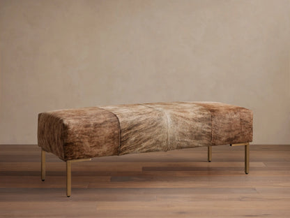Tilton Hair on Hide Bench: long, rectangular, with paneled blonde and brown brindle hide, on four golden metal legs.