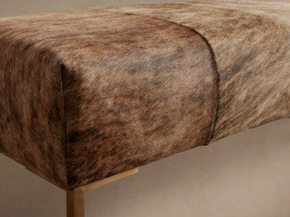 Tilton Hair on Hide Bench: Rectangular, upholstered in brown & blonde hair-on-hide, golden metal legs, on a wooden floor.