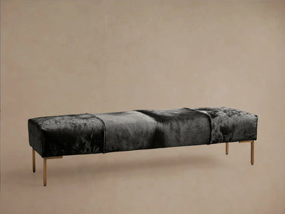 Tilton Hair on Hide Bench with natural, undyed leather in varying shades of brown. Rectangular shape on solid black metal legs, set on wooden floor.