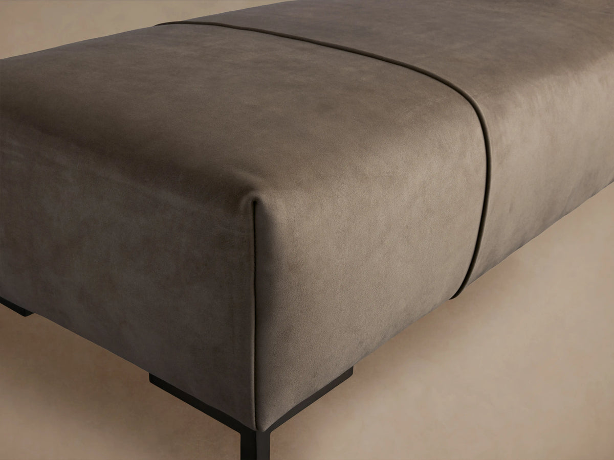 Tilton Hair on Hide Bench with a smooth, gray, rectangular seat featuring subtle seam details, supported by slim, black metal legs.